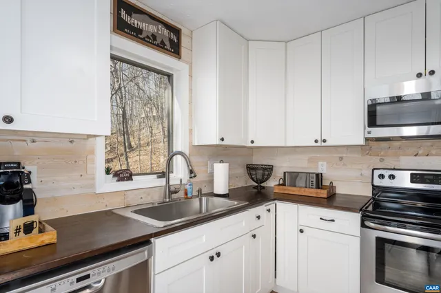 a kitchen with a sink stove and cabinets
