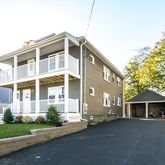 a front view of a house with a garden