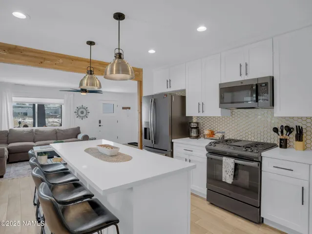 a kitchen that has a stove a sink and a refrigerator