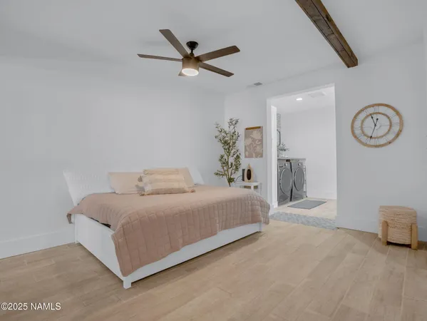 a spacious bedroom with a bed and a chandelier