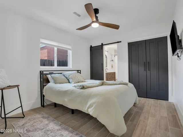 a bedroom with a bed and a chandelier