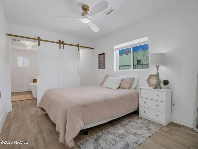 a bedroom with a large bed and a window