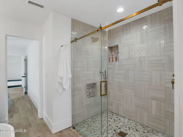 a bathroom with a shower and a sink