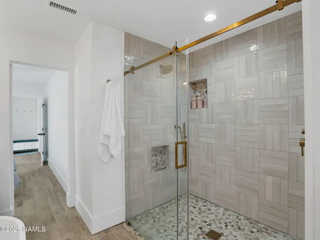 a bathroom with a shower and a sink