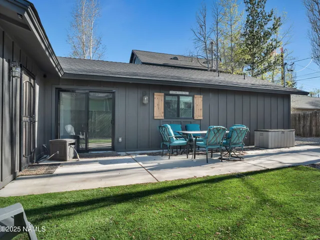 a view of backyard with outdoor seating and patio