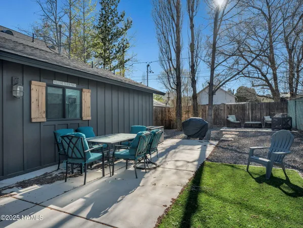 a view of backyard with patio