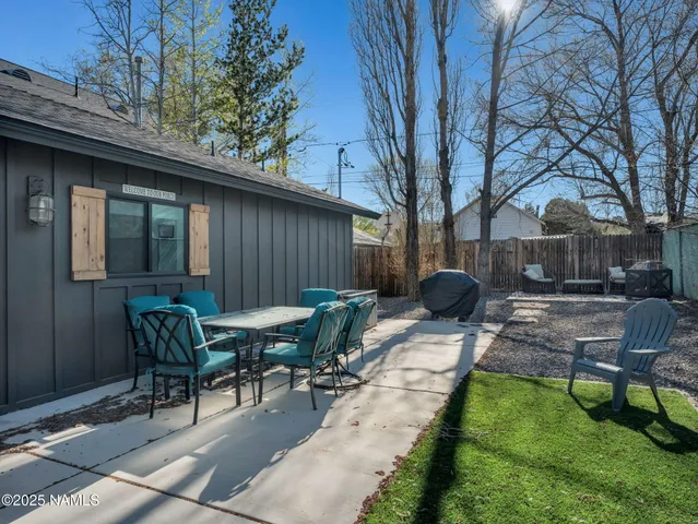 a view of backyard with patio