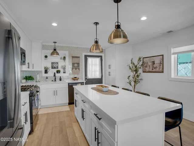 a kitchen that has a lot of cabinets in it