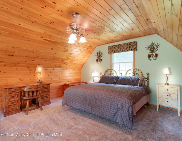 a bed room with a bed and a chandelier