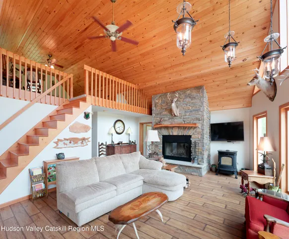 a living room with furniture a fireplace and a flat screen tv