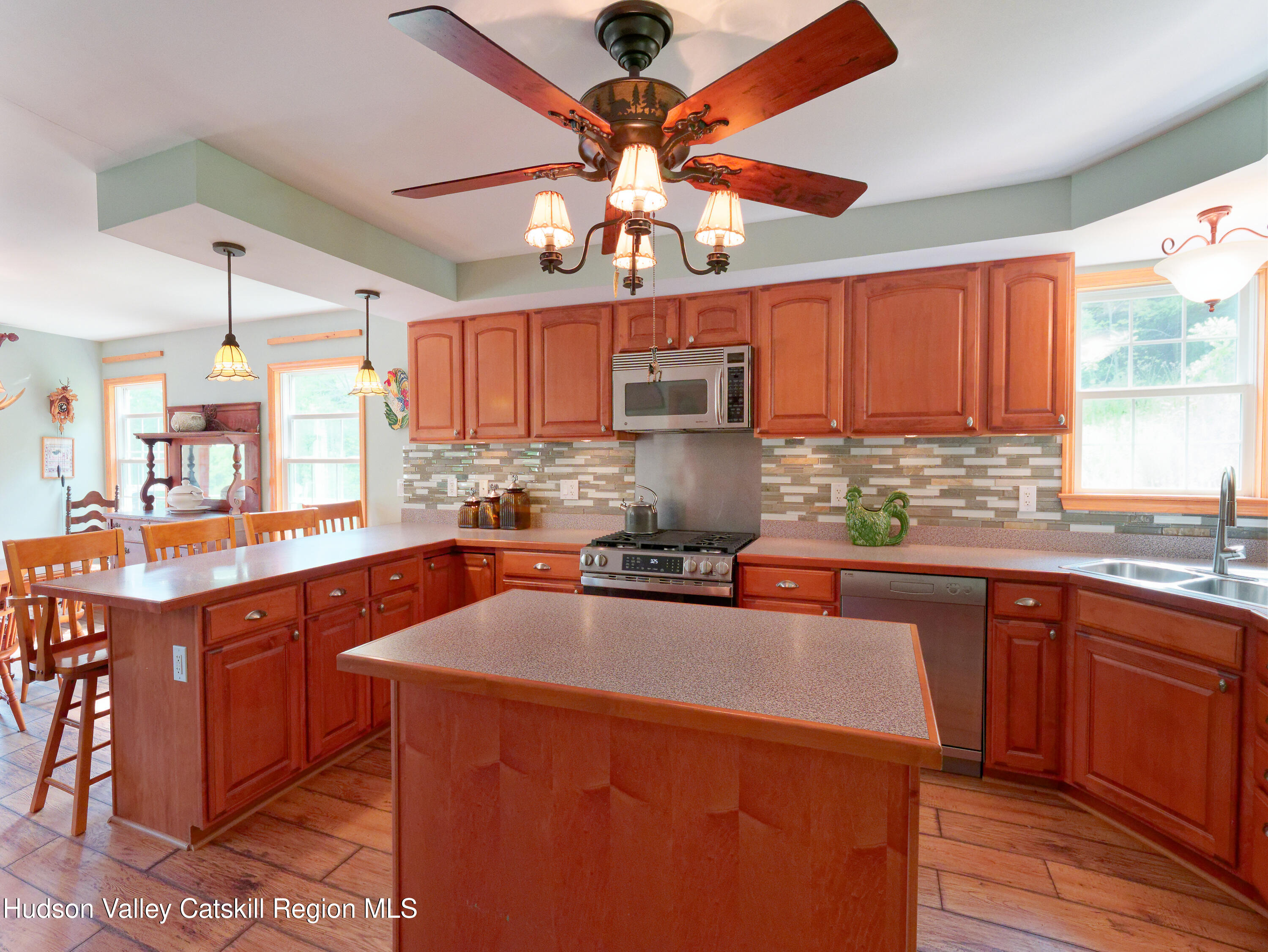 1324 Hauverville Road Middleburgh, NY 12122 - Photo 7 of 28 a kitchen with stainless steel appliances a sink a stove a refrigerator cabinets and a large window