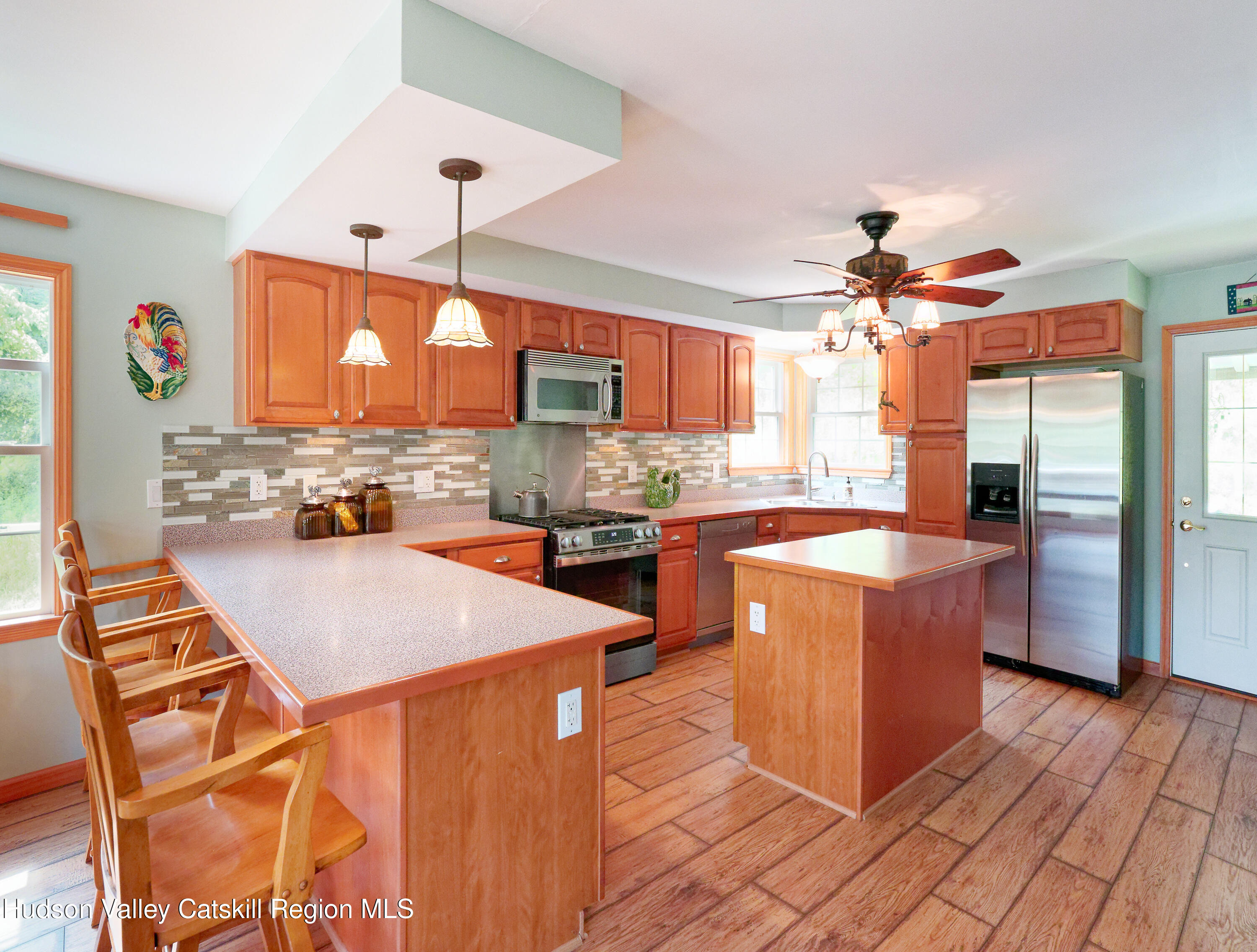1324 Hauverville Road Middleburgh, NY 12122 - Photo 8 of 28 a kitchen with stainless steel appliances kitchen island granite countertop a stove a sink and a refrigerator
