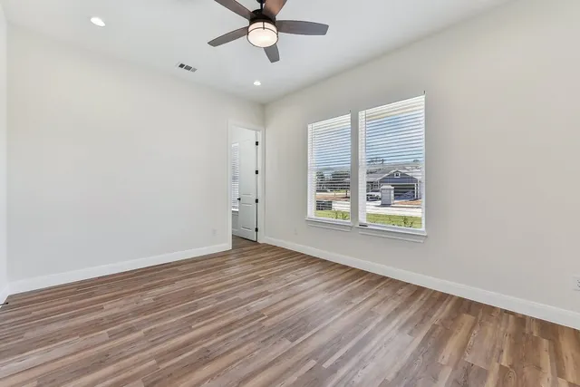 a bedroom with a large bed and a flat screen tv