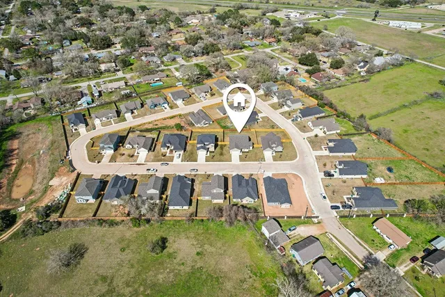 an aerial view of residential houses with outdoor space