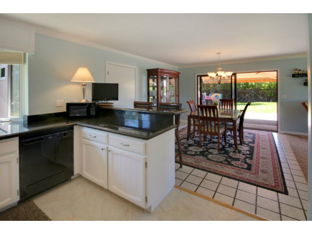 105 Corralitos Road Corralitos, CA 95076 - Photo 4 of 25 a kitchen with granite countertop a stove a sink a dining table and chairs