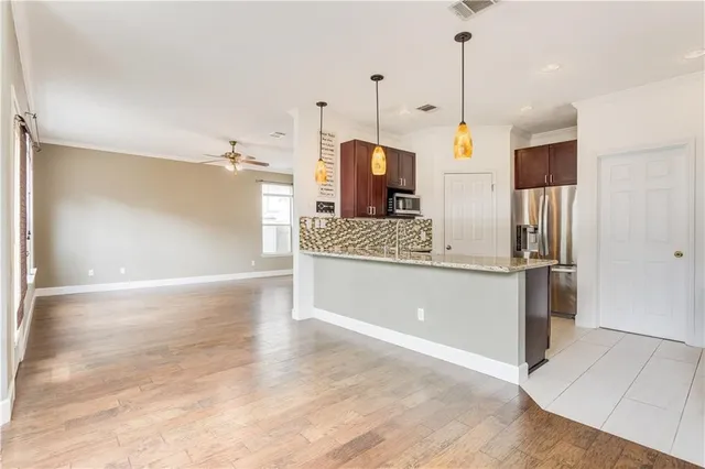 a large kitchen with kitchen island a stove a refrigerator and a sink