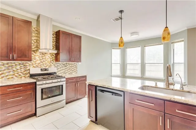 a kitchen with granite countertop white cabinets and a sink