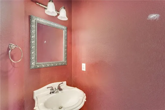 a bathroom with a sink mirror and vanity