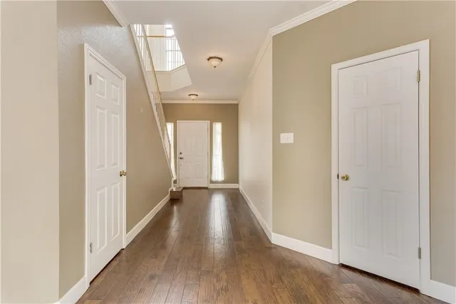 a view of a hallway with wooden floor