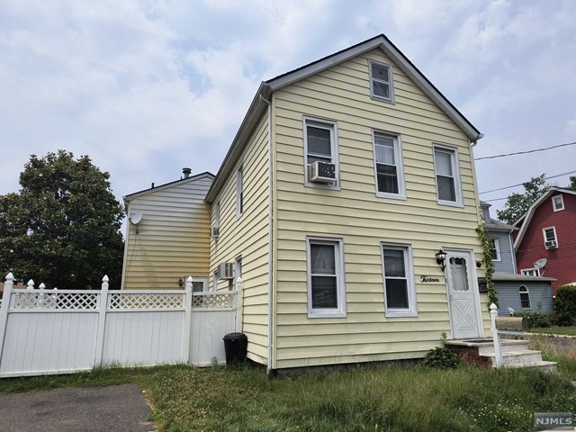 13 Garden Street Little Ferry, NJ 07643 - Photo 1 of 42 a view of a white house with a small yard and a large window