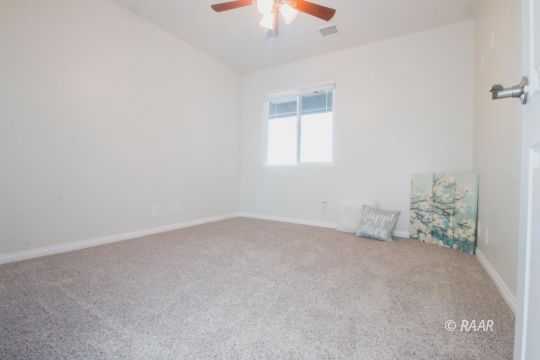 1113 Mayo Street Ridgecrest, CA 93555 - Photo 18 of 31 an empty room with a chandelier fan