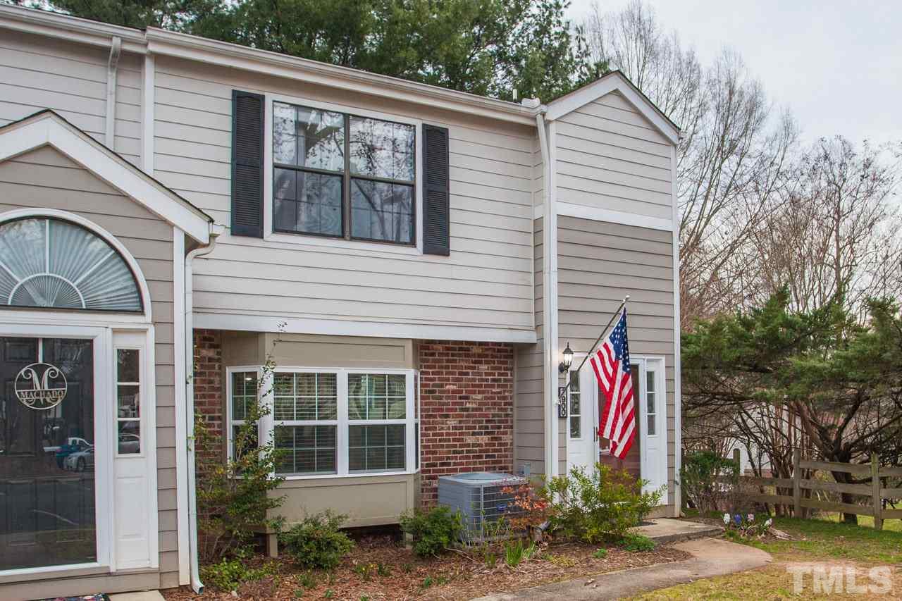 7900 Falcon Rest Circle, Unit 10 Raleigh, NC 27615 - Photo 2 of 25 a front view of a house with a yard and garage