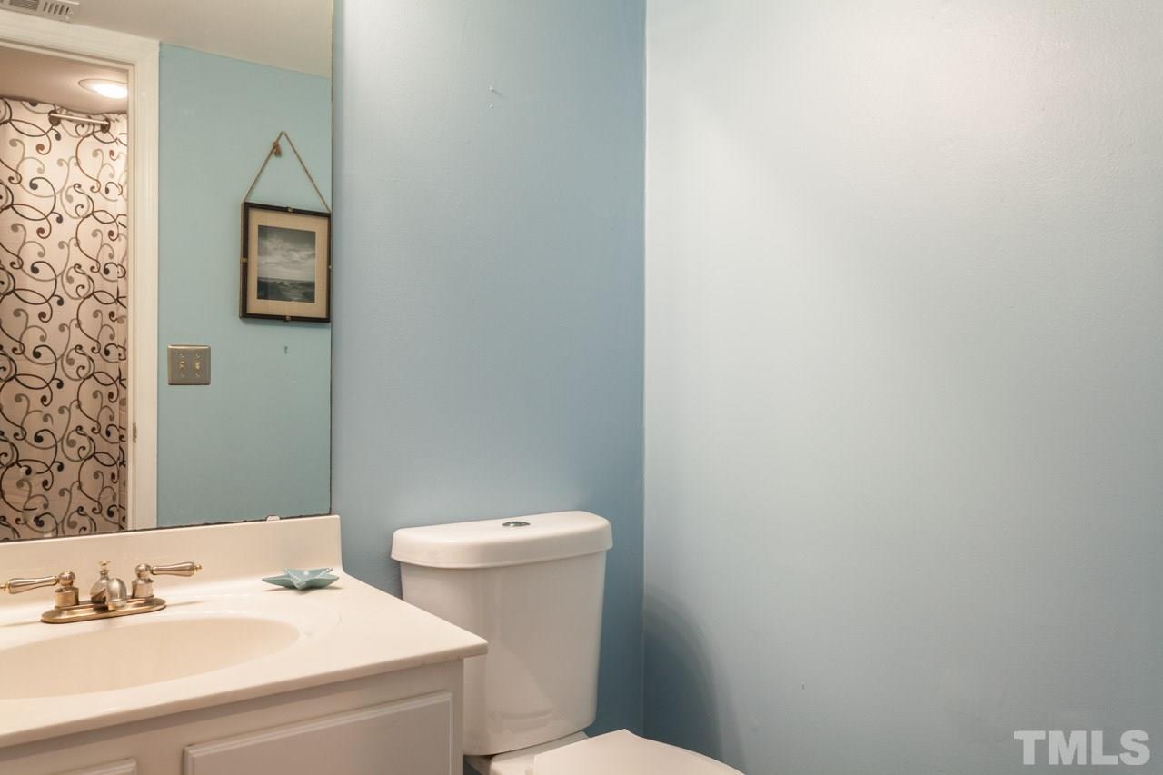 7900 Falcon Rest Circle, Unit 10 Raleigh, NC 27615 - Photo 16 of 25 a bathroom with a sink and a mirror