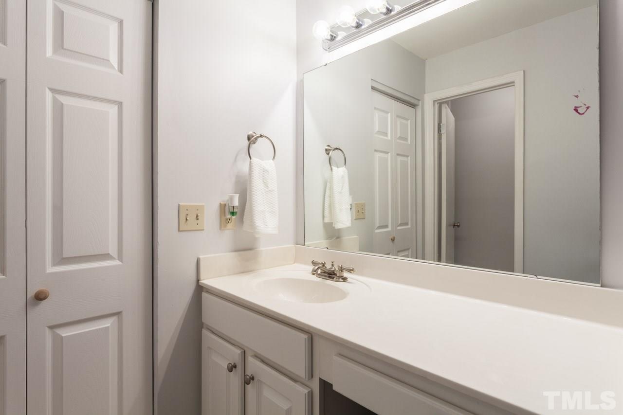 7900 Falcon Rest Circle, Unit 10 Raleigh, NC 27615 - Photo 19 of 25 a bathroom with a sink double vanity and a mirror