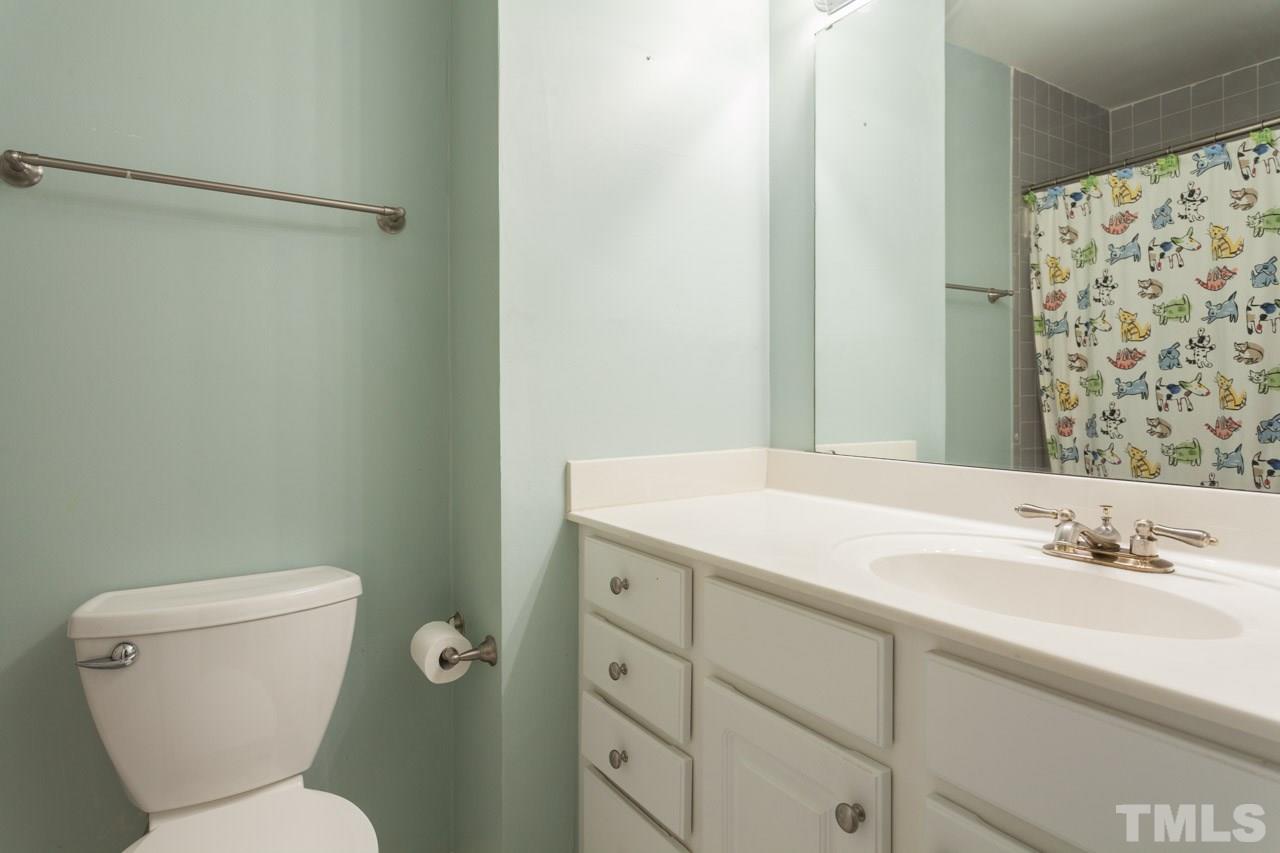 7900 Falcon Rest Circle, Unit 10 Raleigh, NC 27615 - Photo 21 of 25 a bathroom with a granite countertop sink toilet and shower