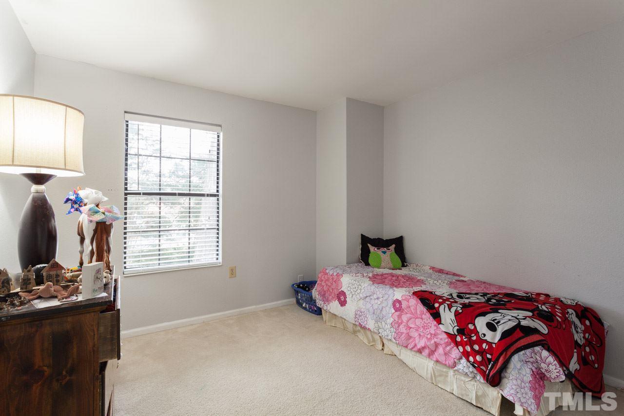 7900 Falcon Rest Circle, Unit 10 Raleigh, NC 27615 - Photo 22 of 25 a bedroom with a bed and window