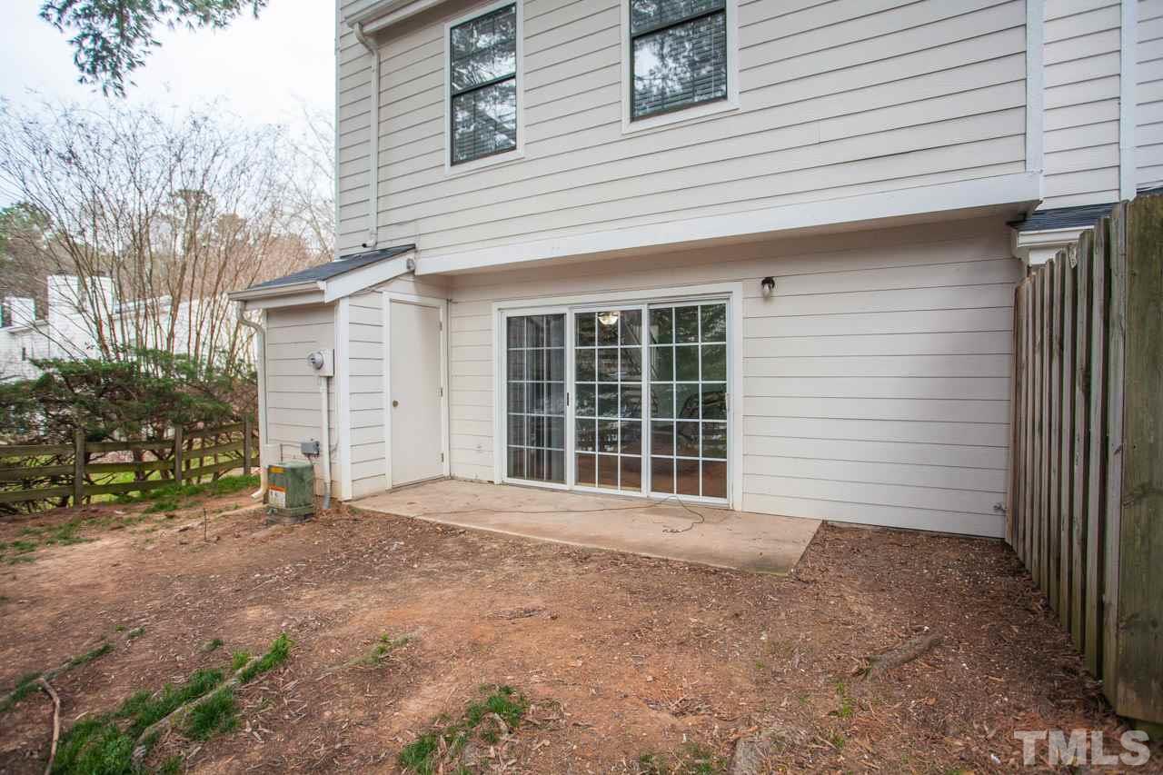 7900 Falcon Rest Circle, Unit 10 Raleigh, NC 27615 - Photo 24 of 25 a view of a house with a yard and garage