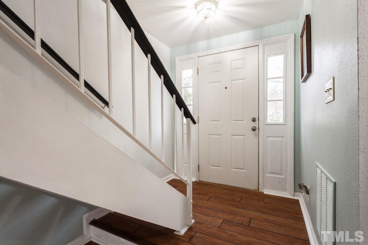 7900 Falcon Rest Circle, Unit 10 Raleigh, NC 27615 - Photo 4 of 25 a view of a hallway with wooden floor and staircase