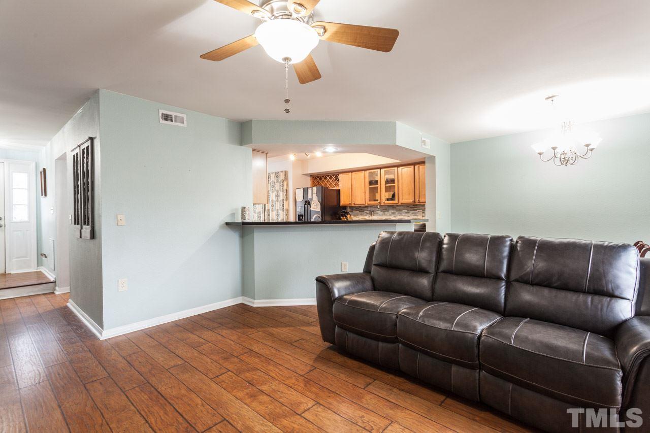 7900 Falcon Rest Circle, Unit 10 Raleigh, NC 27615 - Photo 7 of 25 a living room with furniture and a flat screen tv
