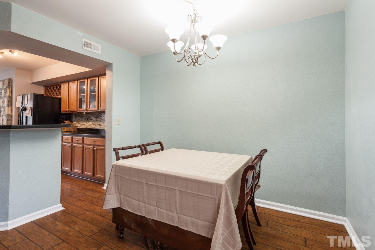 7900 Falcon Rest Circle, Unit 10 Raleigh, NC 27615 - Photo 10 of 25 a dining room with a table chairs and kitchen view