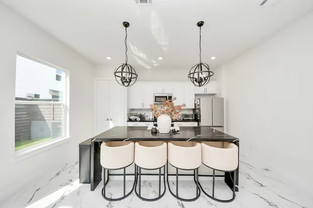 a dining room with furniture and window