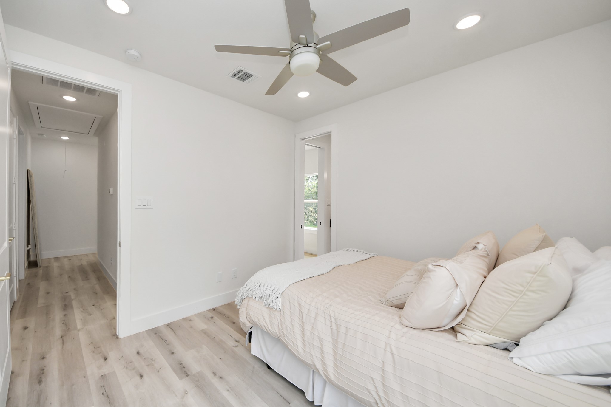 6549 Sealey Street Houston, TX 77091 - Photo 28 of 40 a bedroom with a large bed and a chandelier