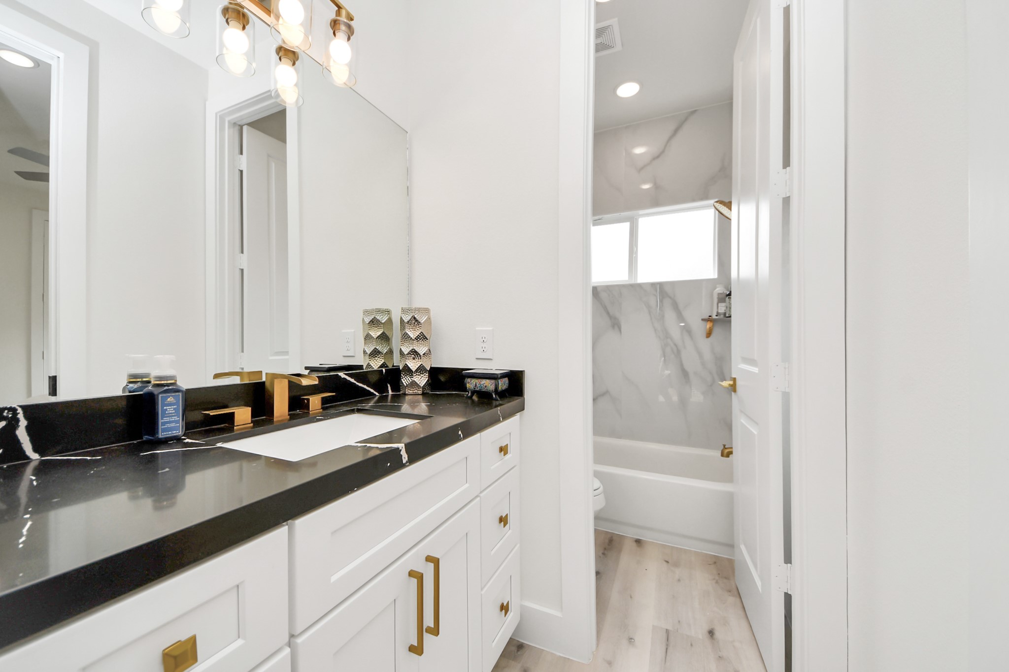 6549 Sealey Street Houston, TX 77091 - Photo 29 of 40 a bathroom with a double vanity sink and mirror with shower