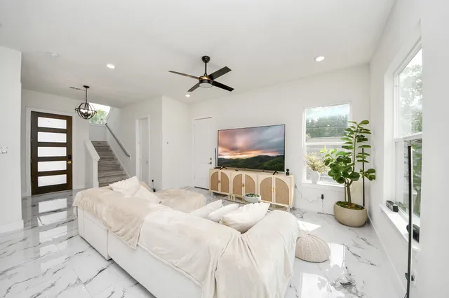 a bedroom with furniture and a flat screen tv