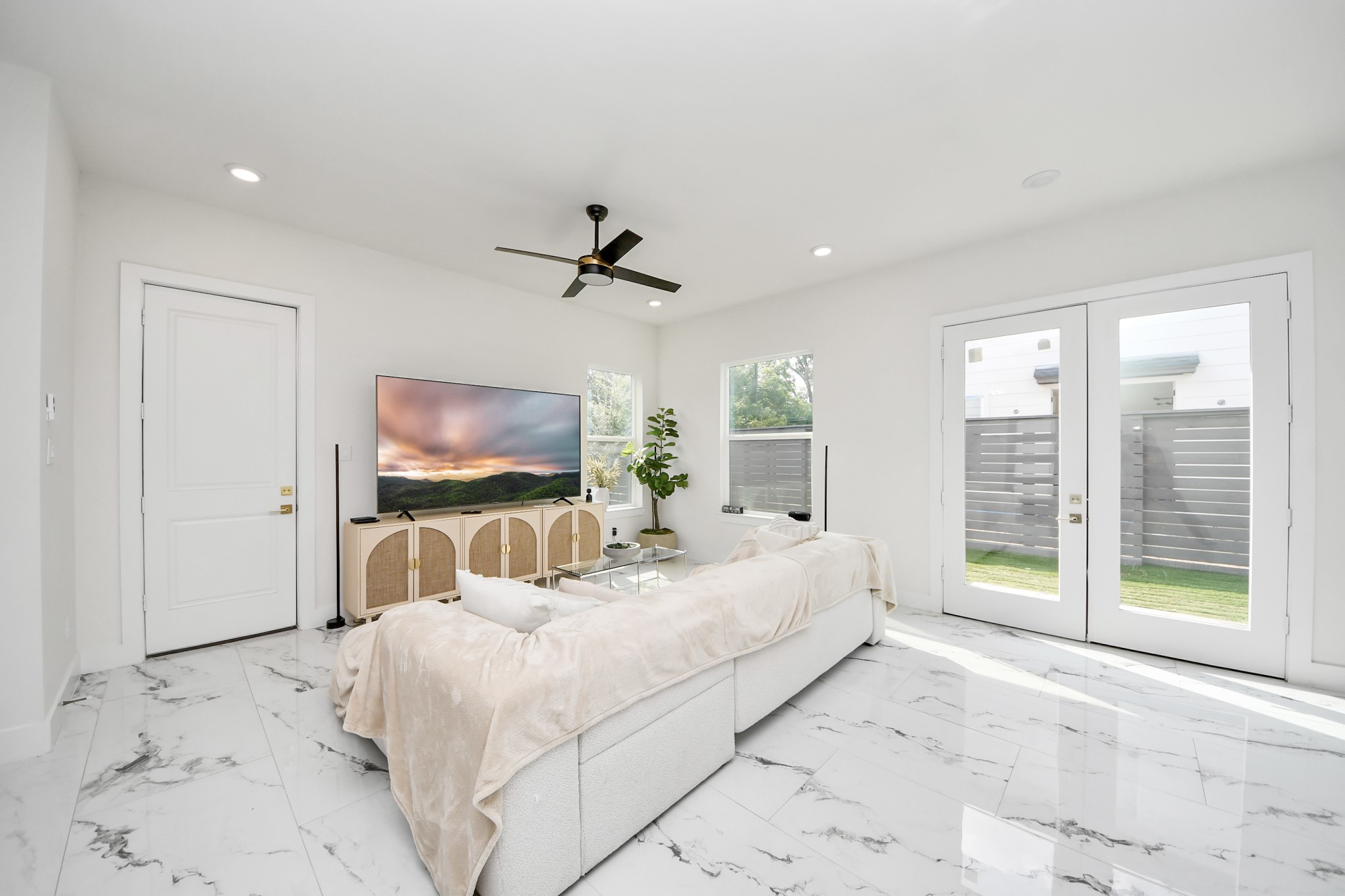 6549 Sealey Street Houston, TX 77091 - Photo 4 of 40 a bedroom with a large bed and a flat tv screen