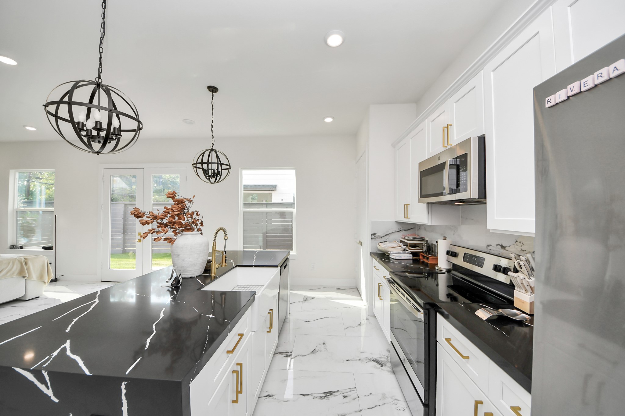 6549 Sealey Street Houston, TX 77091 - Photo 10 of 40 a kitchen with granite countertop stainless steel appliances a stove a sink a refrigerator and a dining table with wooden floor