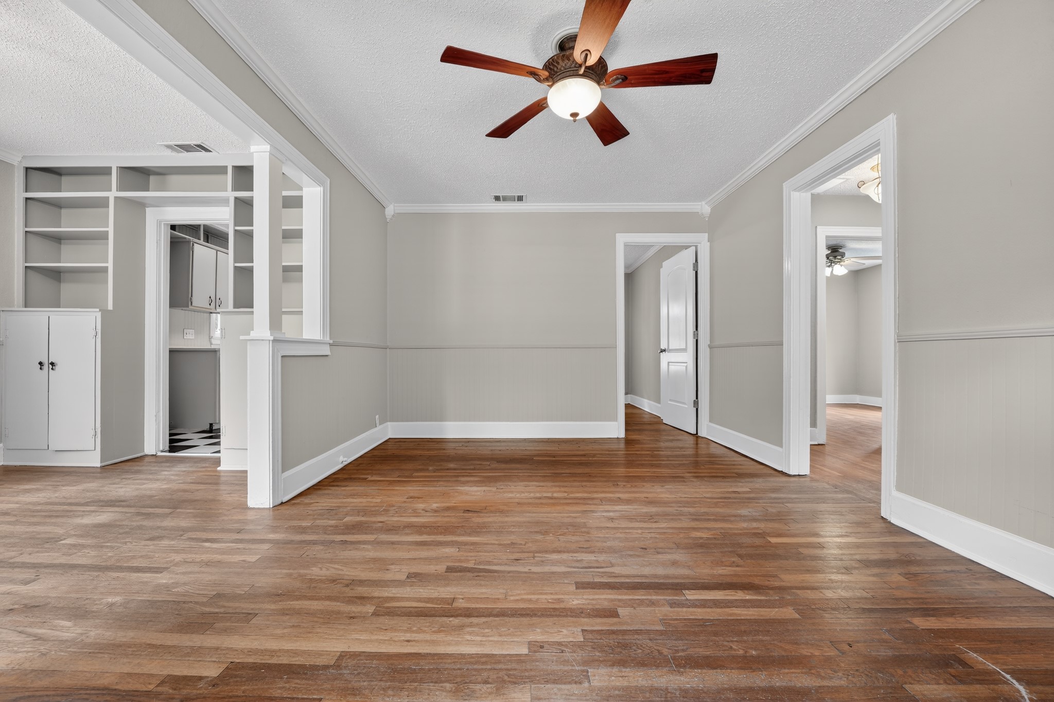 4907 Duval Street Austin, TX 78751 - Photo 7 of 31 a view of empty room with wooden floor and fan