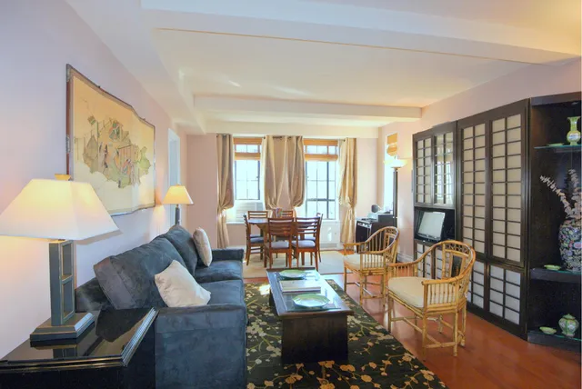 a living room with furniture and a lamp