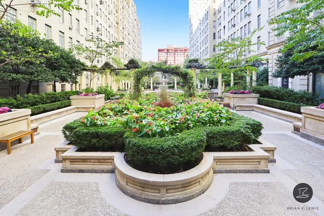 a front view of a multi story residential apartment building with yard