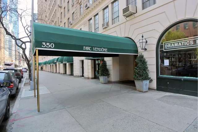a dining room with furniture a chandelier and wooden floor