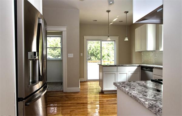 28 Woodman Road Worcester, MA 01602 - Photo 13 of 30 a kitchen with stainless steel appliances granite countertop a sink stove and refrigerator