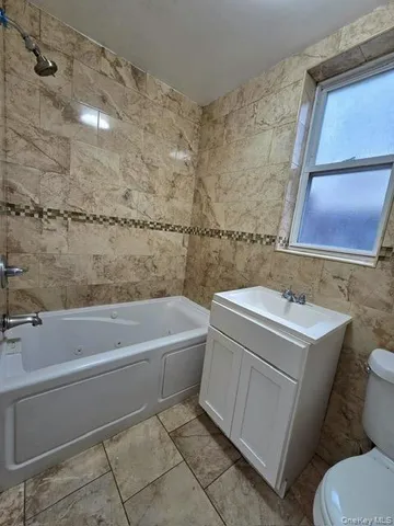 a bathroom with a sink a toilet and bathtub
