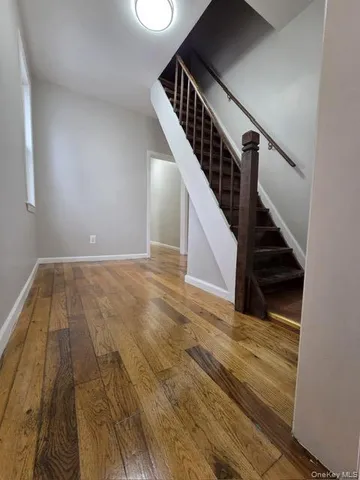 a view of entryway and hall with wooden floor