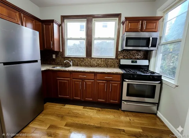 a kitchen with granite countertop a refrigerator stove and microwave