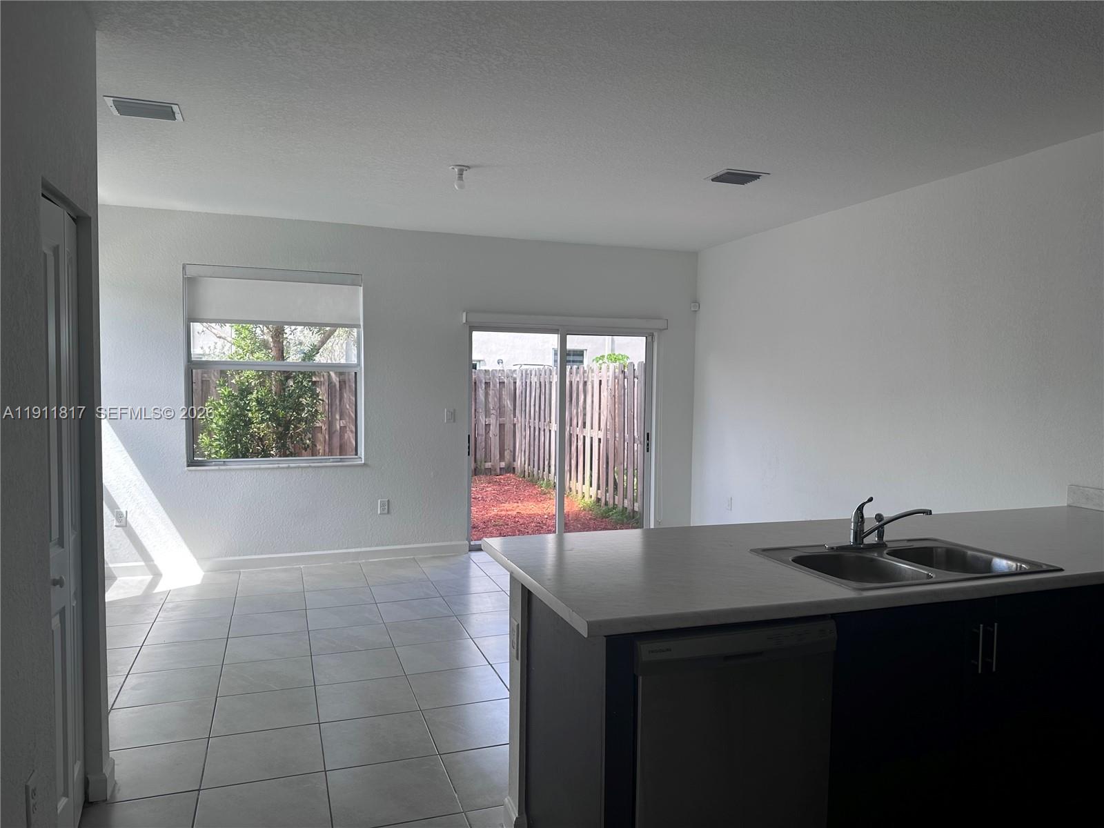 1884 Southeast 27th Street Homestead, FL 33035 - Photo 11 of 34 a kitchen with a sink and a window