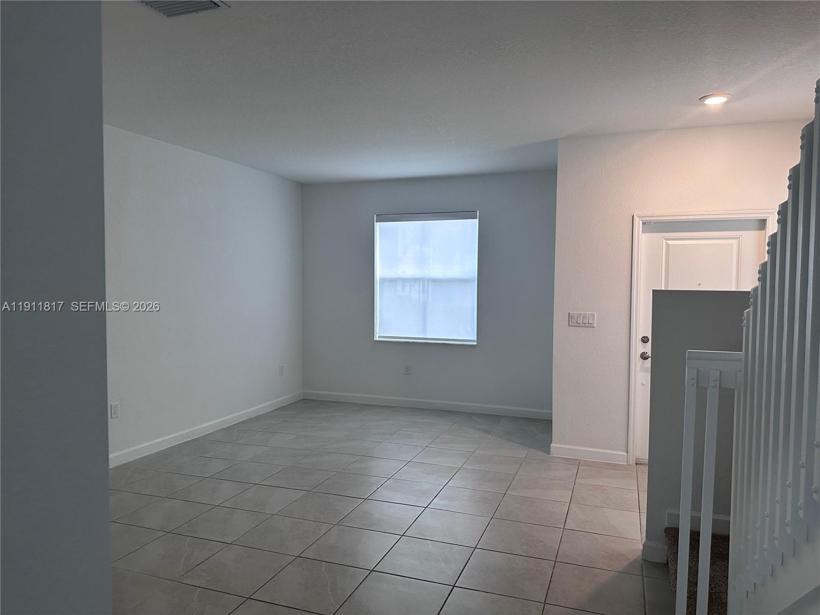 1884 Southeast 27th Street Homestead, FL 33035 - Photo 13 of 34 an empty room with a empty space and windows